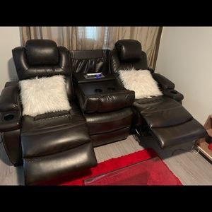 A living room set a love seat and couch. 4 recliners, 4 electric head rest.